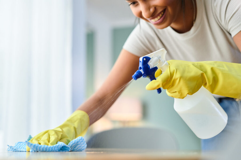 wiping a surface while spraying